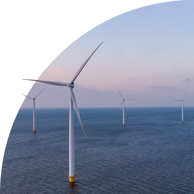 Offshore wind farm with turbines in the sea at dusk